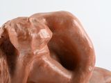 a clay sculpture of a man and a dog on a table