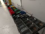 many bins of screws and nuts on the floor