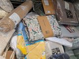 several rolls of fabric are stacked on top of each other on a shelf