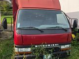a red truck that is parked in the grass