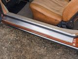a brown car with a tan seat and a tan seat cover