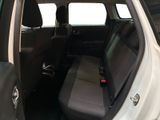 the back seats of a white car with a black seat belt