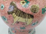 a pink vase with a picture of a lion on it