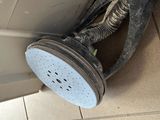 a dirty shower head on the floor of a bathroom