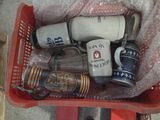 a red basket filled with different types of mugs