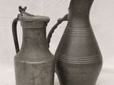 two vases sitting next to each other on a white surface