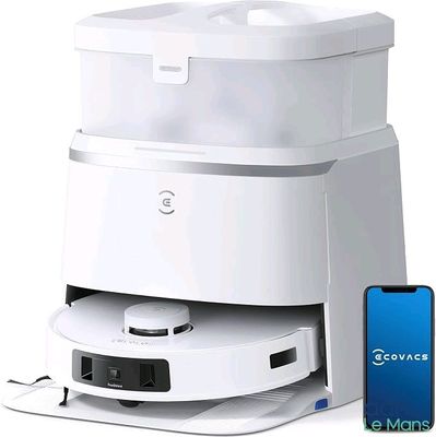 a white machine that is sitting next to a cell phone