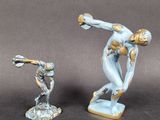 two figurines of a man and a woman on a table