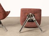 pair of mid - century modern lounge chairs in red velvet upholstered with metal legs