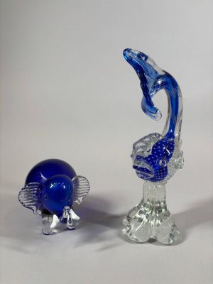 three glass figurines that are sitting on a table