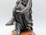 an image of a statue of a woman sitting on top of a table