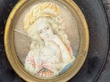a picture of a woman in a hat on a plate