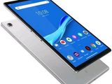 a close up of a tablet with a phone on top of it