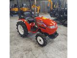 a red tractor parked in a warehouse with other tractors