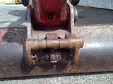 a close up of a rusted pipe with a chain attached to it
