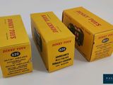 three boxes of dinky toys are sitting next to each other