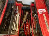 many tools in a red tool box on the floor