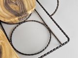 a picture of a wooden tray with a ring on top of it