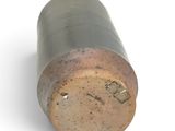 a small metal object that is sitting on a white surface