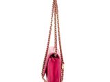 a pink purse with a chain strap hanging from it ' s side