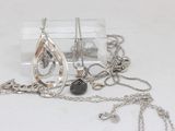 a necklace with a tear on it and a necklace with a tear on it