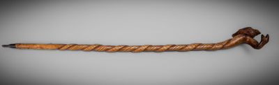 a pipe with a wooden handle on a white surface