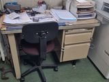 a desk with a computer and a printer on it