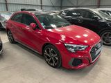 a red audi car parked in a garage next to other cars