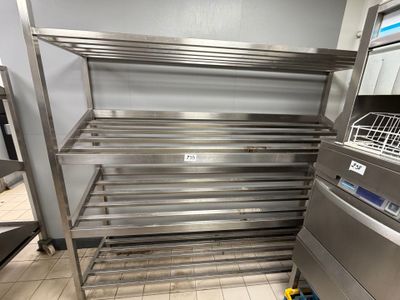a stainless steel shelf in the middle of a kitchen