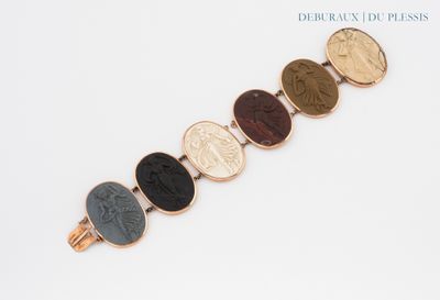 a close up of a bracelet with a coin on it