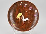an image of a decorative plate with a horse and flowers on it