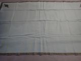 an image of a white table cloth with a brown border
