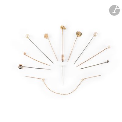 a clock made out of gold and silver pins on a white background