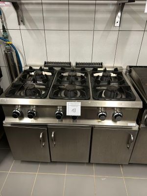 four burners on the stove in the kitchen
