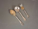 three spoons and a fork on a table