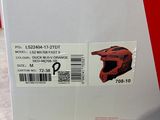a box with a red helmet on it sitting on a table