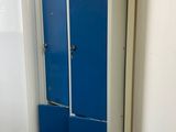 two blue lockers next to each other in a room