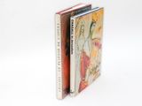 two books are stacked on top of each other on a white surface