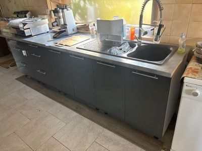 a kitchen with a sink, dishwasher, and a dishwasher