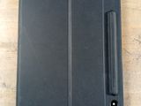 an open black tablet computer sitting on top of a wooden table