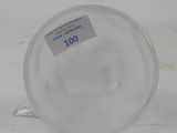 a clear cup with a sticker on it sitting on a table