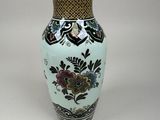 a vase that is sitting on a white surface