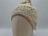 the hat is knitted and has a pom pom on top of it