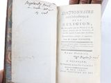 a person holding an open book in their hand