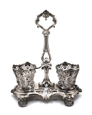 a pair of silver candlesticks on a stand on a white background
