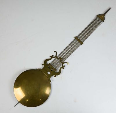 a clock that is hanging on the wall with a chain around it