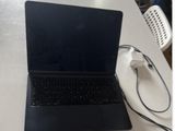 a laptop that is sitting on a table with a charger
