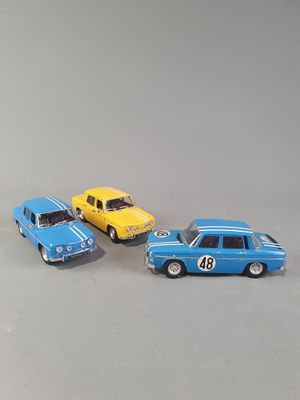 three toy cars sitting next to each other on a table