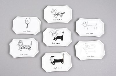 six assiettes blanches ornées de dessins d'animaux sur un fond gris