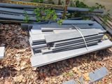 many pieces of metal laying on the ground in the yard